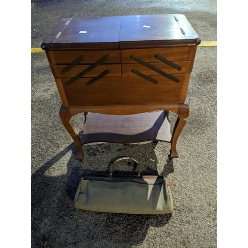 530 - An early 20th century mahogany sewing box with cantilevered top, on cabriole legs, fitted interior w... 