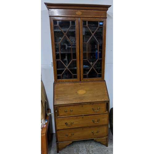 541 - An Edwardian Sheraton revival inlaid walnut and mahogany bureau bookcase, astragal glazed twin displ... 