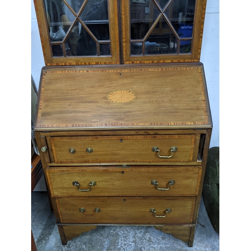 541 - An Edwardian Sheraton revival inlaid walnut and mahogany bureau bookcase, astragal glazed twin displ... 