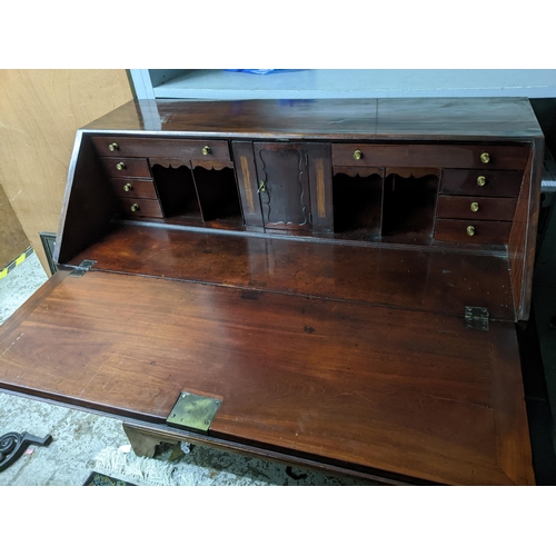 391 - A Georgian flame mahogany bureau, fall flap revealing a fitted pigeonhole interior of a central cupb... 