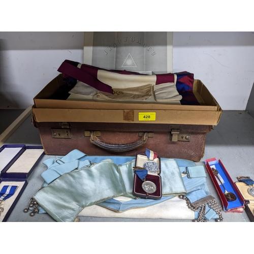 428 - A leather case containing Masonic aprons, and various medals to include a silver WMSS Prize medal, a... 