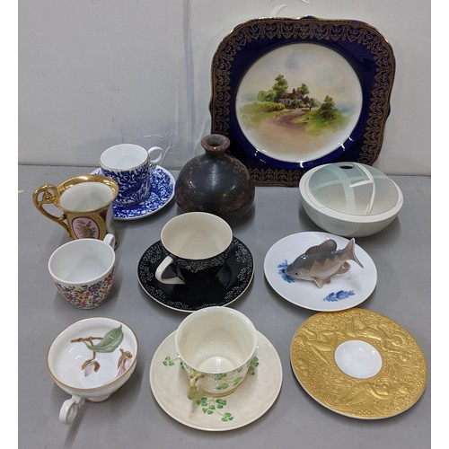 521 - A mixed lot to include a Royal Copenhagen fish, Belleek cup and saucer, Studio pottery lidded bowl, ... 