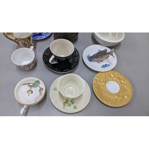 521 - A mixed lot to include a Royal Copenhagen fish, Belleek cup and saucer, Studio pottery lidded bowl, ... 