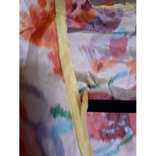 273 - A vintage silk blouse A/F having a multi-coloured floral pattern throughout with yellow piping to th... 