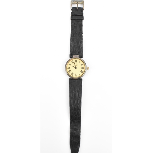 601 - A Dunhill, quartz, ladies, silver gilt wristwatch, having a textured gilt dial, Roman numerals, on a... 