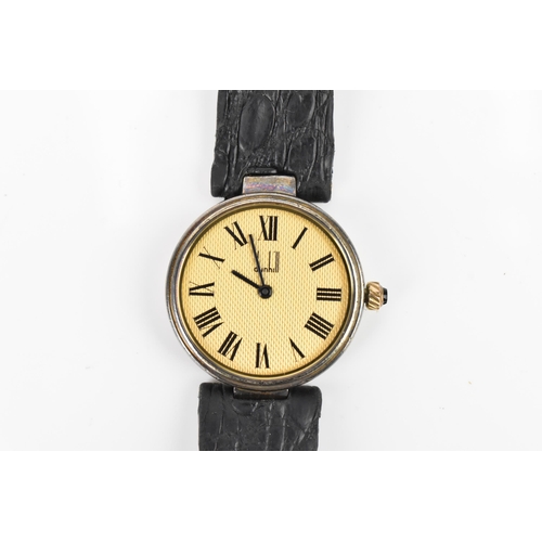 601 - A Dunhill, quartz, ladies, silver gilt wristwatch, having a textured gilt dial, Roman numerals, on a... 