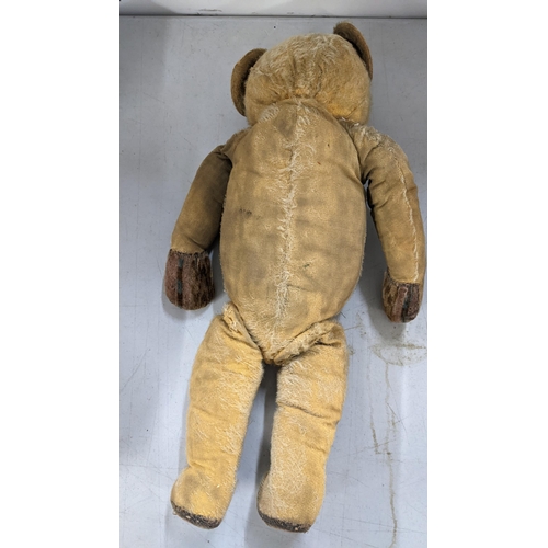 519 - A mixed lot to include an early century mohair and wood wool filled bear with growler, wedding veils... 