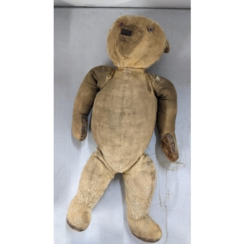 519 - A mixed lot to include an early century mohair and wood wool filled bear with growler, wedding veils... 