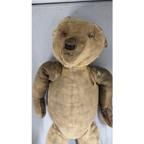 519 - A mixed lot to include an early century mohair and wood wool filled bear with growler, wedding veils... 