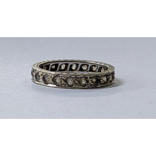 100 - A white metal full eternity band inset with white sapphires, 2.1g
Location: CAB5