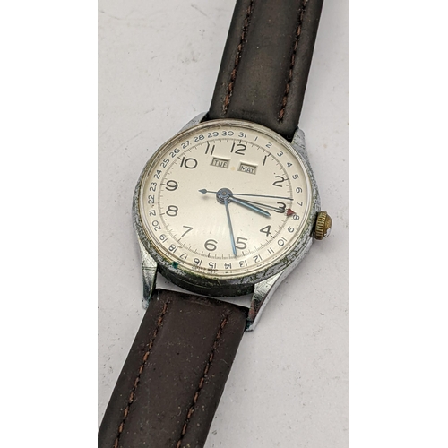 107 - A mid 20th century gents stainless steel triple day, date and month
Location: CAB2