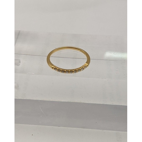 137 - An 18ct gold ring with a band of diamonds, 1.5g
Location: CAB5