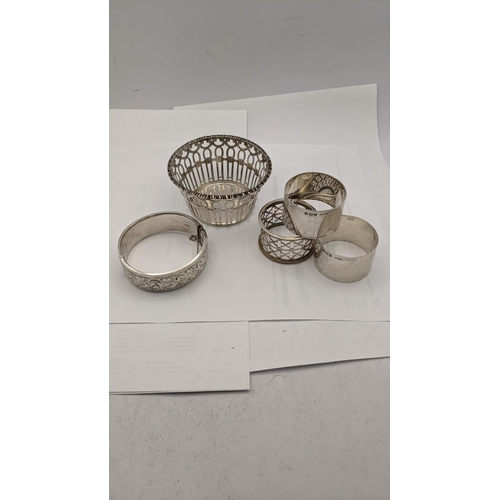 142 - Silver compromising of three napkin rings, a pierced bowl, along with a bracelet having engraved dec... 