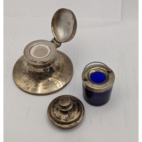 149 - Silver to include a caption inkwell, a dish, a lid, a glass salt and a blue glass and silver plated ... 