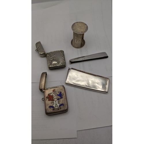 158 - Silver to include an enamelled vesta engraved Liberte, silver coloured vesta, a napkin ring and a ca... 