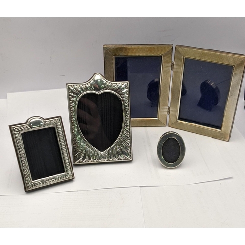 159 - Silver photograph frames to include a double frame two modern embossed frames and a small oval examp... 