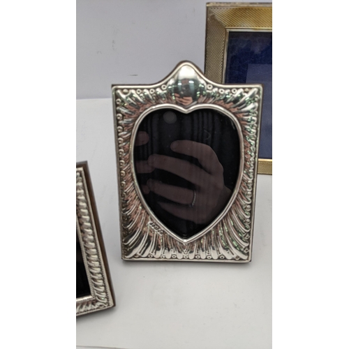 159 - Silver photograph frames to include a double frame two modern embossed frames and a small oval examp... 