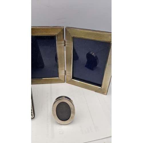 159 - Silver photograph frames to include a double frame two modern embossed frames and a small oval examp... 