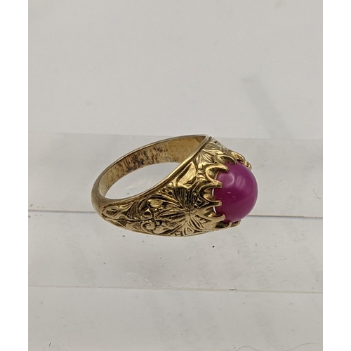 174 - A gold coloured ring set with a pink cabochon, 8.8g
Location: CAB7