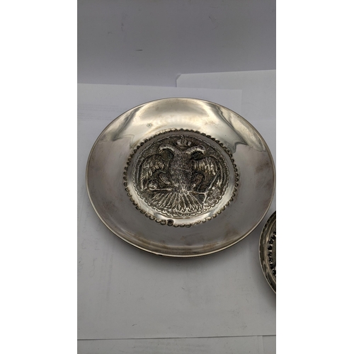 206 - A Cypriot silver dish with embossed ornament and another decorated with a rim 145g
Location: