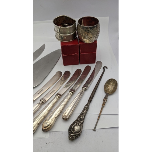 211 - Three silver napkin rings 55g silver handled knives, bread knife, button hook and cake knife
Locatio... 