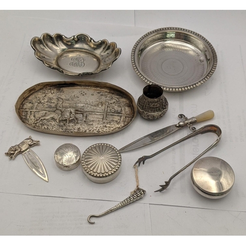 212 - Silver to include a coaster, a dish, a Victorian dish, two pill boxes, a page marker, a glove button... 