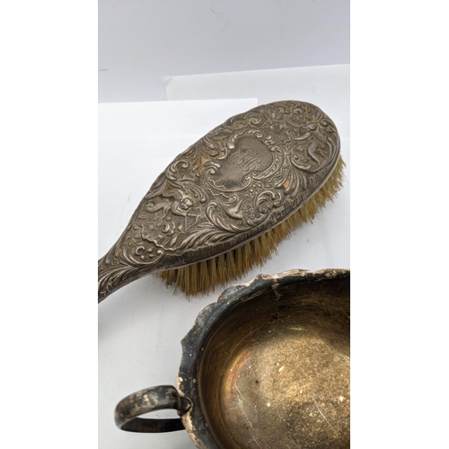 219 - A silver sauce boat hallmarked Sheffield 1933 101.5g, together with a silver embossed dressing table... 