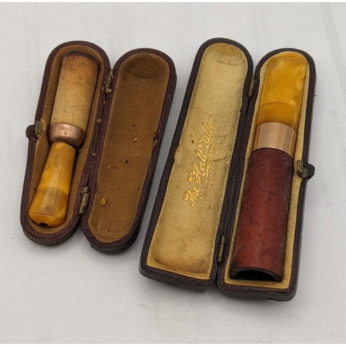 221 - A Cheroot holder A/F having an amber coloured mouth piece and a 9ct gold band, together with a cigar... 