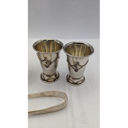 229 - White metal and sterling silver o include a pair of sugar tongs stamped 800, a pair of liquor glasse... 