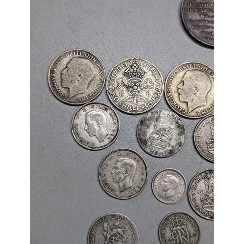 489 - British coins - a small group of pre-1947 florins, shillings, sixpence and threepence, along with a ... 