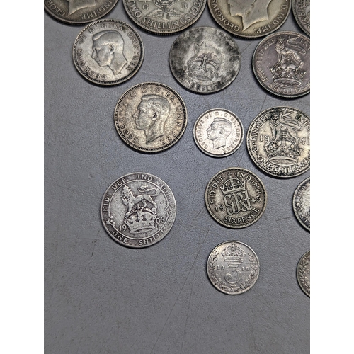 489 - British coins - a small group of pre-1947 florins, shillings, sixpence and threepence, along with a ... 