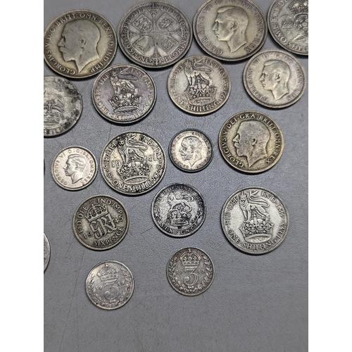 489 - British coins - a small group of pre-1947 florins, shillings, sixpence and threepence, along with a ... 