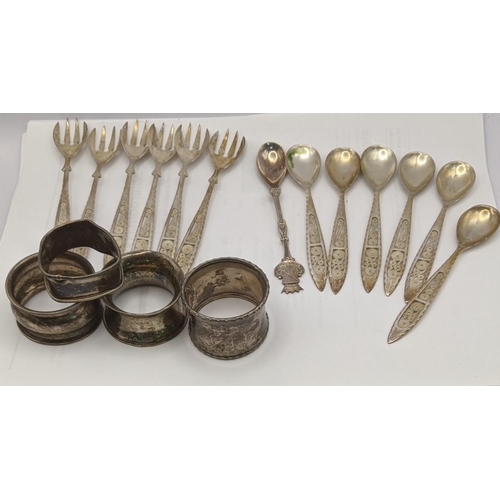 66 - Silver and white metal to include filigree teaspoons stamped 830 with four napkin rings, total weigh... 