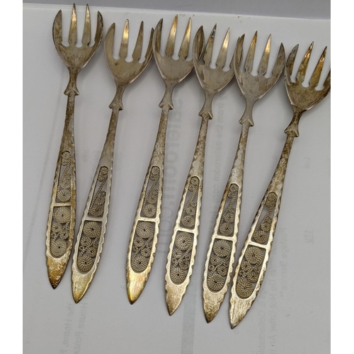 66 - Silver and white metal to include filigree teaspoons stamped 830 with four napkin rings, total weigh... 