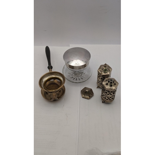 69 - A pair of silver pierced salt and pepper pots, together with a silver lidded dressing table pot, alo... 