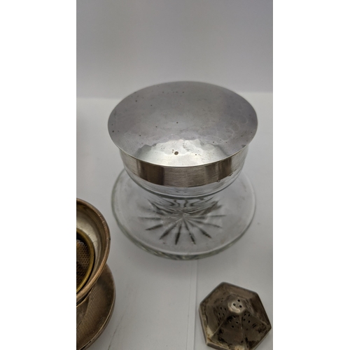 69 - A pair of silver pierced salt and pepper pots, together with a silver lidded dressing table pot, alo... 