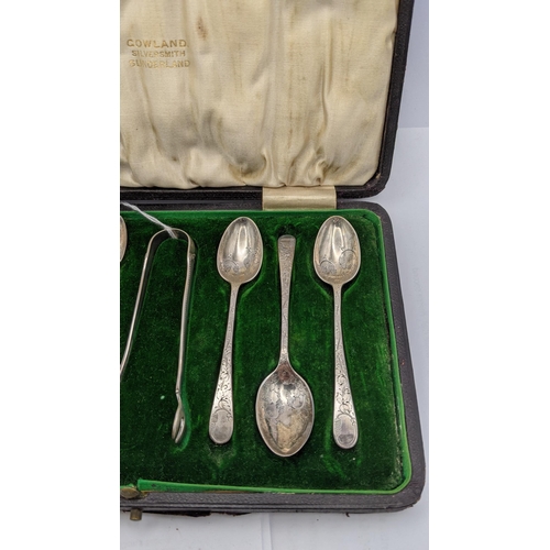 72 - A cased set of silver spoons along with a pair of sugar thongs having a floral engraved design total... 