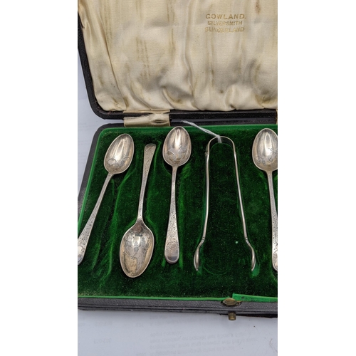 72 - A cased set of silver spoons along with a pair of sugar thongs having a floral engraved design total... 