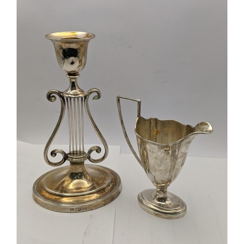 81 - A silver candle stick holder weighted hallmarked London 1902, together with a silver jug 113.1g
Loca... 