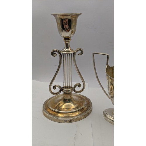 81 - A silver candle stick holder weighted hallmarked London 1902, together with a silver jug 113.1g
Loca... 