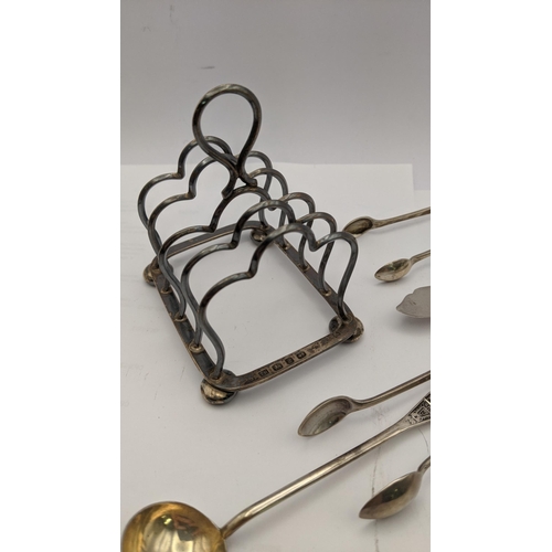 99 - Mixed silver and white metal to include a silver Birmingham 1896 toast rack together with two silver... 