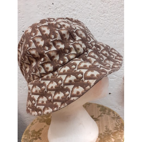 56 - Christian Dior-An early 1980's cotton bucket hat having a cream ground with branded designer name DI... 