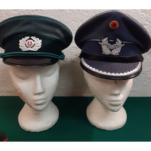 61 - A group of service hats to include a mid 20th Century British Military Army Officer's visor cap and ... 