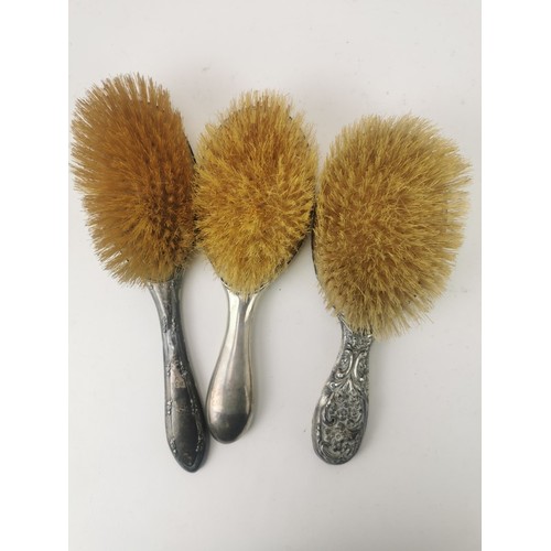 123 - Three dressing table hair brushes to include silver brushes and a white metal embossed hair brush
Lo... 