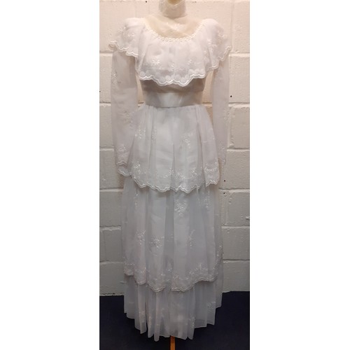 81 - A 1970's sheer white wedding dress UK size 10 with multilayered skirt having embroidered floral spra... 