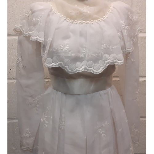 81 - A 1970's sheer white wedding dress UK size 10 with multilayered skirt having embroidered floral spra... 