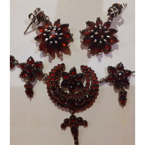 83 - An early 20th Century white metal and garnet coloured stone necklace having crescent moon and floral... 