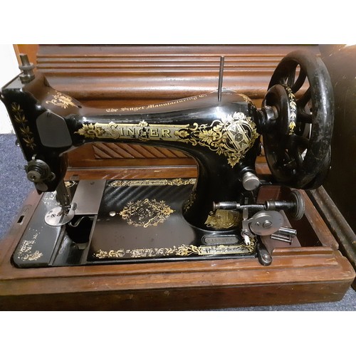 175 - Two vintage Singer sewing machines comprising a 1908 model in an oak case serial no:V125208 and a 19... 