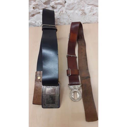 89 - Two vintage leather belts comprising a London Scottish Volunteers brown belt and a Scottish black le... 