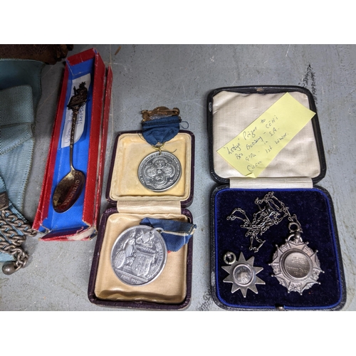 187 - **THIS LOT HAS BEEN WITHDRAWN**
A leather case containing Masonic aprons, and various medals to incl... 